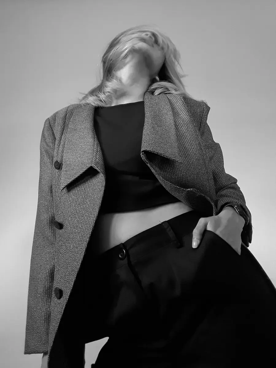 Model wearing a tailored grey coat